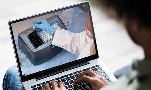 Person on a laptop watching an eLearning course